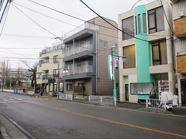 角にヘアーサロンのある路地カフェのある路地入口